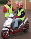 Chris instructs a SYM rider